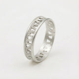 Sterling silver geometric cut-out ring photographed on a white background showing the openwork band.