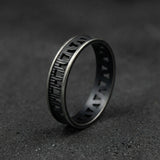 Men’s oxidized silver geometric ring on a dark background showing the openwork band