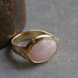 Side view of the handmade gold rose quartz ring showing the bezel height and modern band structure.