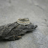 Side view of the sterling silver openwork ring emphasizing its delicate cut-out details.