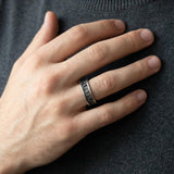 Handmade oxidized silver ring on a male model’s hand near the torso, showing scale, comfort, and modern minimalist styling.