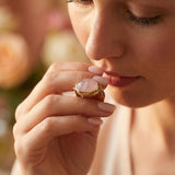 Top-down view of the oval rose quartz gemstone ring showing the stone’s soft translucency.